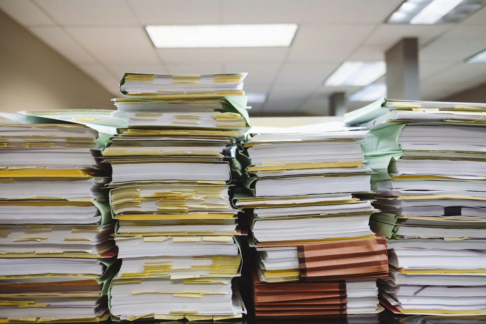 Stacks of disorganized payroll tax paperwork and files